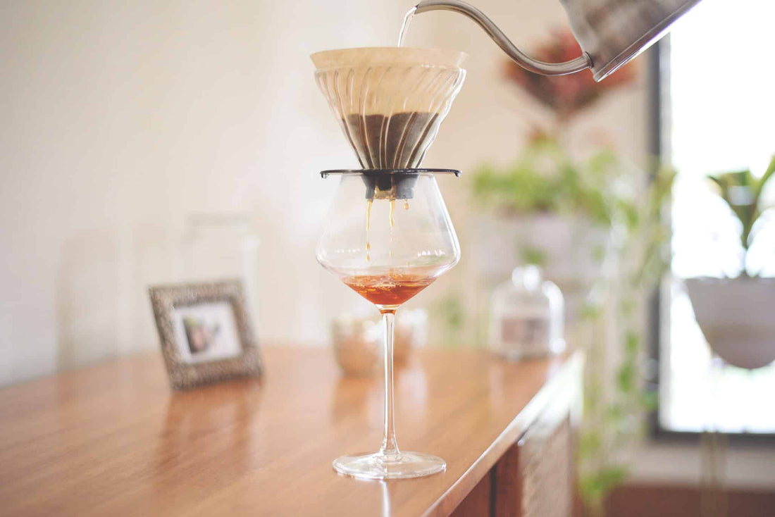 Coffee brewing into a wine glass